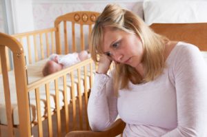 Mother In Nursery Suffering From Post Natal Depression
